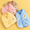 Pink, blue, yellow and beige daisy fleece bunny vests arranged on a warm yellow background.