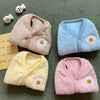 Four folded daisy fleece bunny vests in beige, blue, yellow and pink.