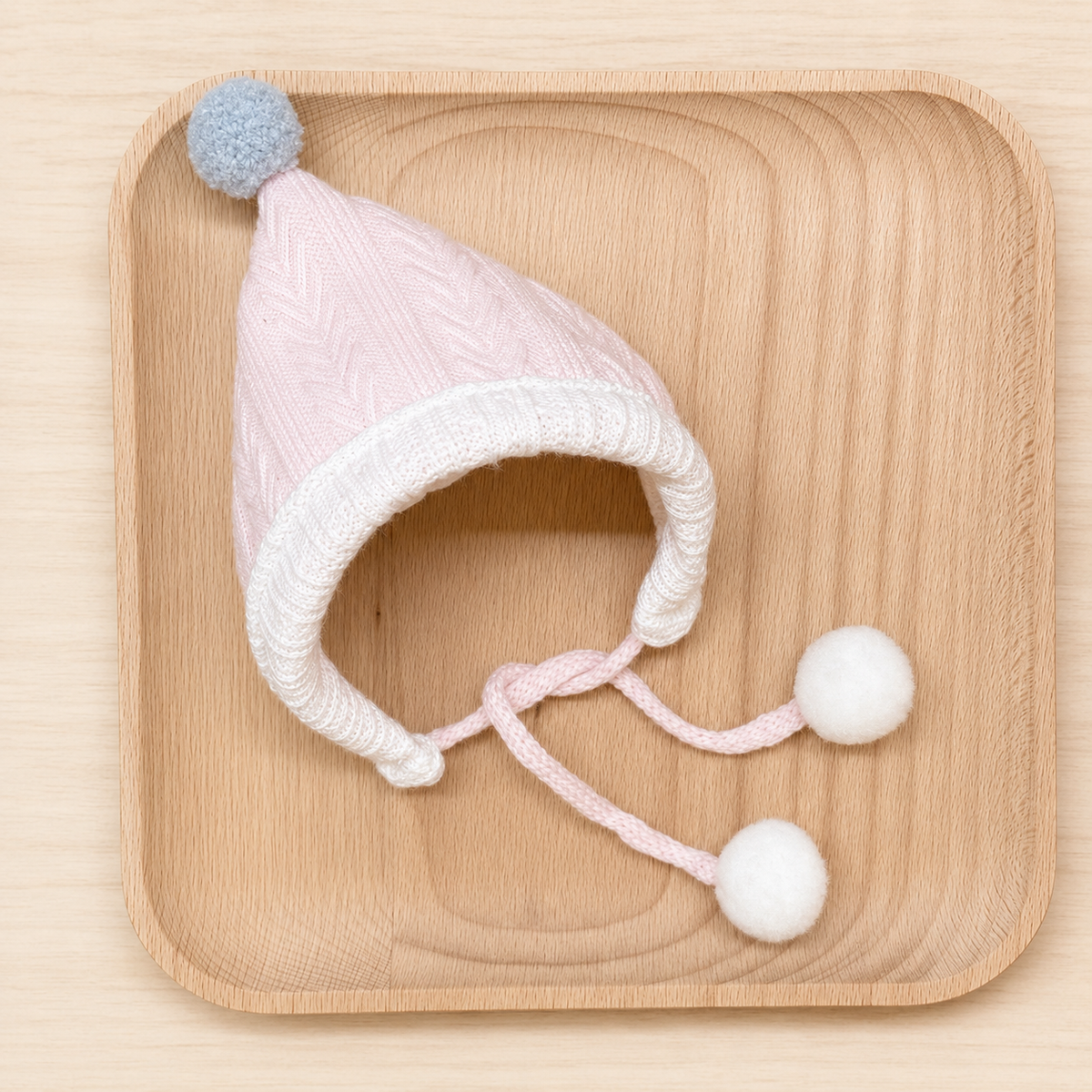 Pink knitted bunny hat with pom-poms for rabbit photos.