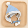 Baby blue knitted bunny hat with white pom-pom for rabbit photos.